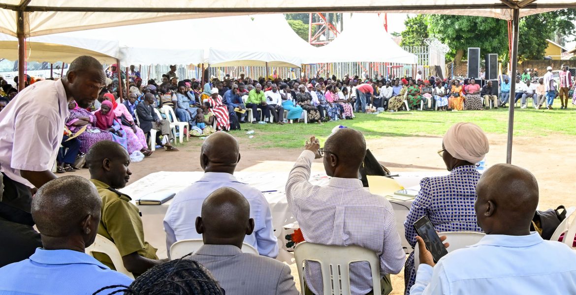 Senior-Presidential-advisor-Moses-Byaruhanga-seated-C-responding-to-some-of-the-querries-raised-by-PDM-beneficiaries-during-a-meeting-in-Luwero-town-on-Monday.-PPU-Photo