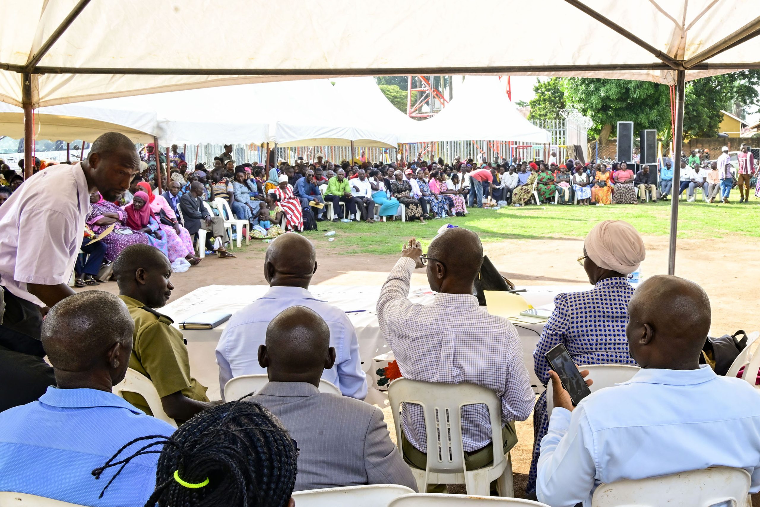 Senior-Presidential-advisor-Moses-Byaruhanga-seated-C-responding-to-some-of-the-querries-raised-by-PDM-beneficiaries-during-a-meeting-in-Luwero-town-on-Monday.-PPU-Photo