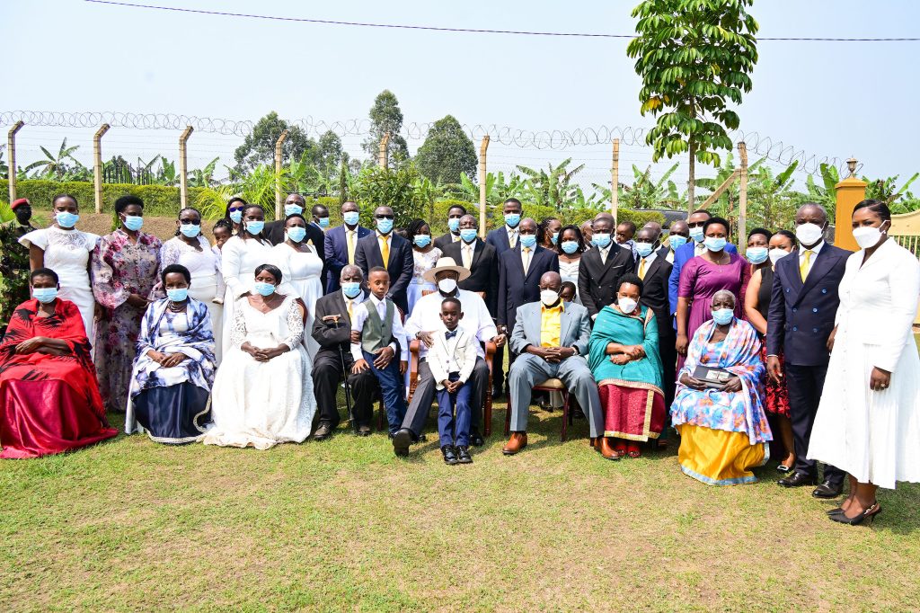 President Museveni (C) poses for a photo with Deputy Speaker Thomas Tayebwa, his family (R) and Mzee Daudi Bangirana and his wife (L) and their relatives during Mzee Bangirana and Hon Tayebwa's thanksgiving