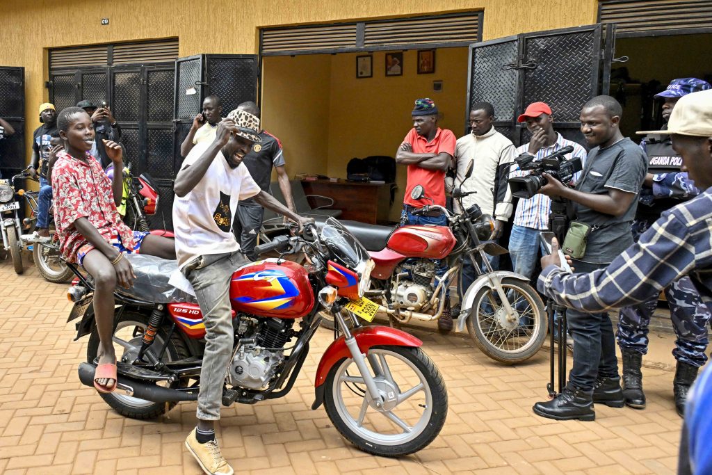 One of the beneficiary shows his excitement after receiving a boda Boda bike, 36 boda bodas were given out by State House Comptroller Jane Barekye that is, 3 bikes for each of the 12 SACCOS in the Kampala Ghetto Structures, the State House Comptroller was fulfilling the pledge made by President Yoweri Kaguta Museveni, the handover of the Boda Bodas took place in Bwaise- Kawempe Division in Kampala on the 4th September 2024. Photo by PPU/ Tony Rujuta.