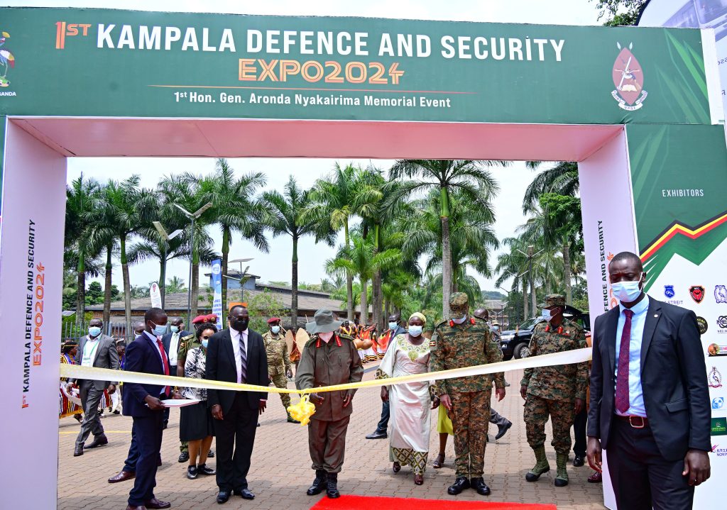 President Museveni accompanied by Chief Justice Owiny Dollo (L), State Minister for Veteran Affairs,  CDF Gen. Muhoozi Kainerugaba (2nd R) cuts the tape as he opens the 1st Kampala Defence and Security Expo