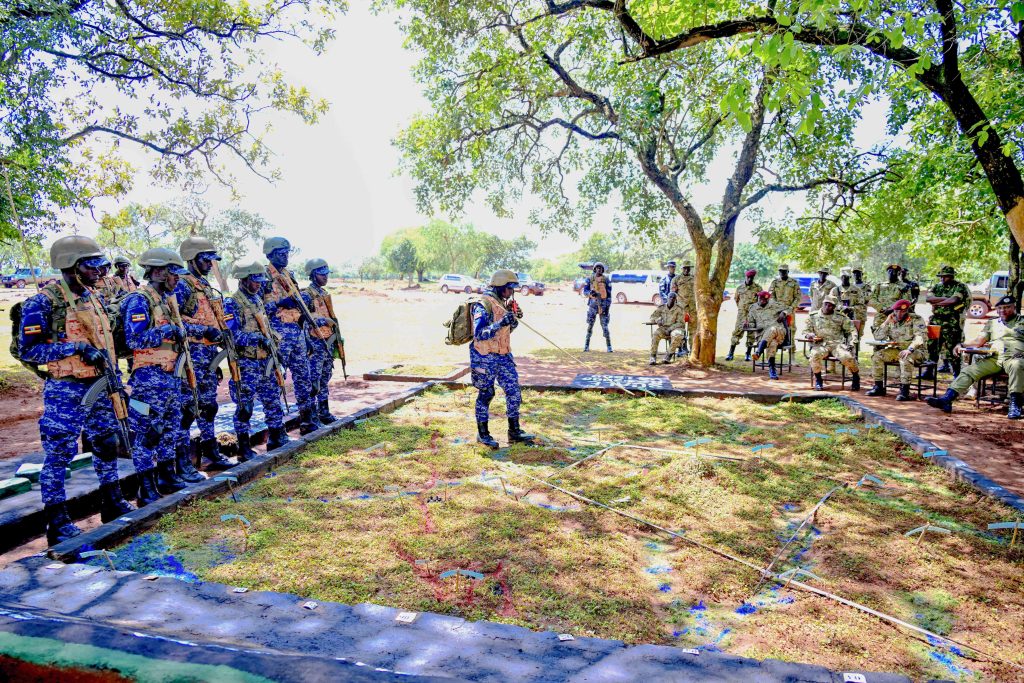 Police Presidential Guard Trainees reading the Exercise open order using a terrain model to Officers  during the Passing out of PPG Trainees at the Police Presidential Guard  Special Force Training School Fort Samora Machel in Kaweweta on the 22nd October 2024. Photo by PPU/Tony Rujuta.