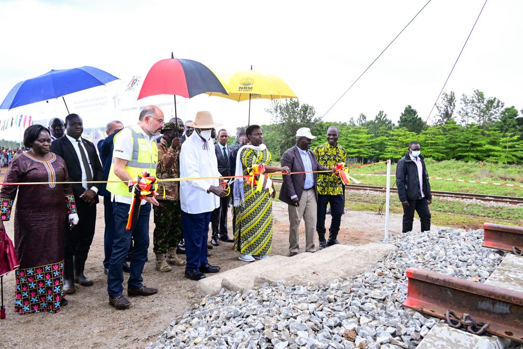 President Museveni accompanied by Yapi Merkezi chairman Erdem Arioglu 2nd L VP Alupo Ministers Katumba Oboth Byabakama and other leaders cuts the tape as he laid the foundation for the construction of the Malaba-Kampala SGR