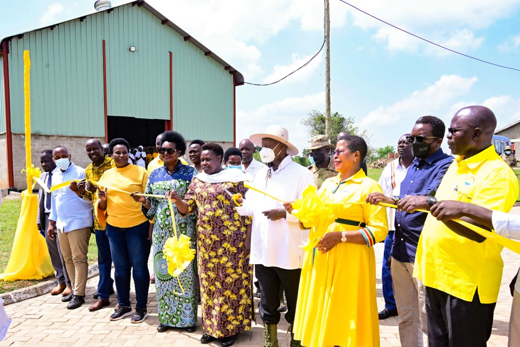 President Museveni cuts the tape as he commissions Teso industrial hub in Soroti City on Tuesday With him are VP Alupo Speaker Among and several ministers and other leaders. PPU Photo