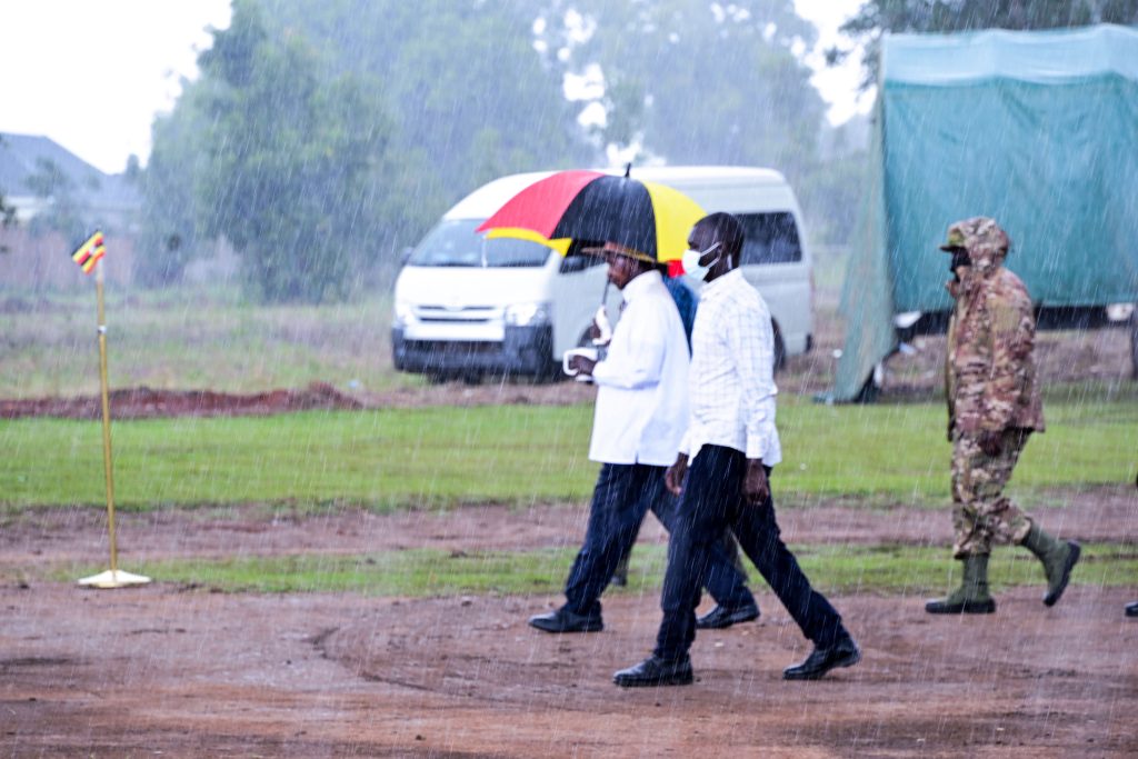 President Museveni walks through a heavey afternoon downpour after addressing a PDM rally at Kaberamaido Primary School grounds in Kaberamaido town on Wednesday PPU Photo