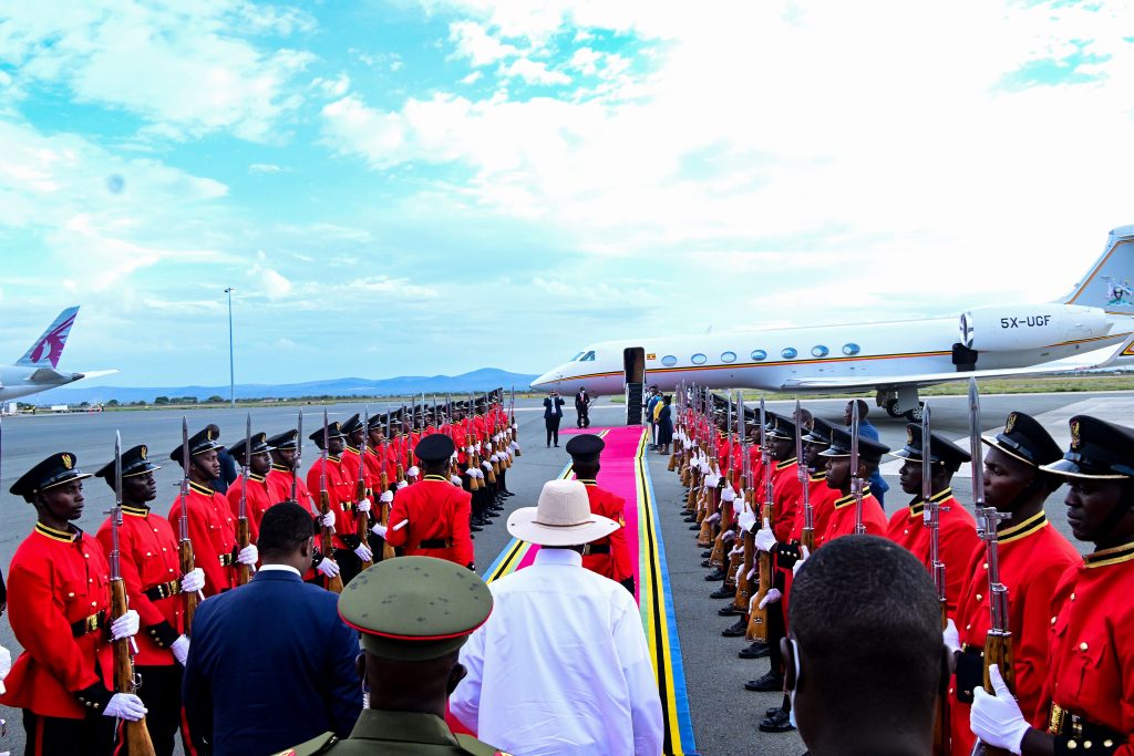 President Museveni walks through a military guard of honour as he leaves Kilimanjaro International airport in Tanania for Entebbe after attending the EAC summit in Arusha PPU Photo