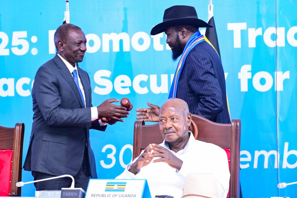 South Sudan President Salva Kiir hands over the chairmanship of the EAC to President William Ruto of Kenya as President Museveni looks on PPU Photo