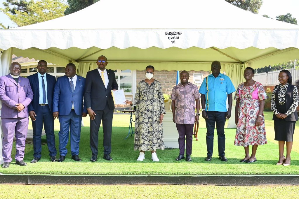 Mrs. Janet Museveni hands over an 18.455-hectare land title for the stadium's construction to Ambrose Tashobya, Chairperson of the National Council of Sports (NCS). State House, Nakasero. PPU Photo