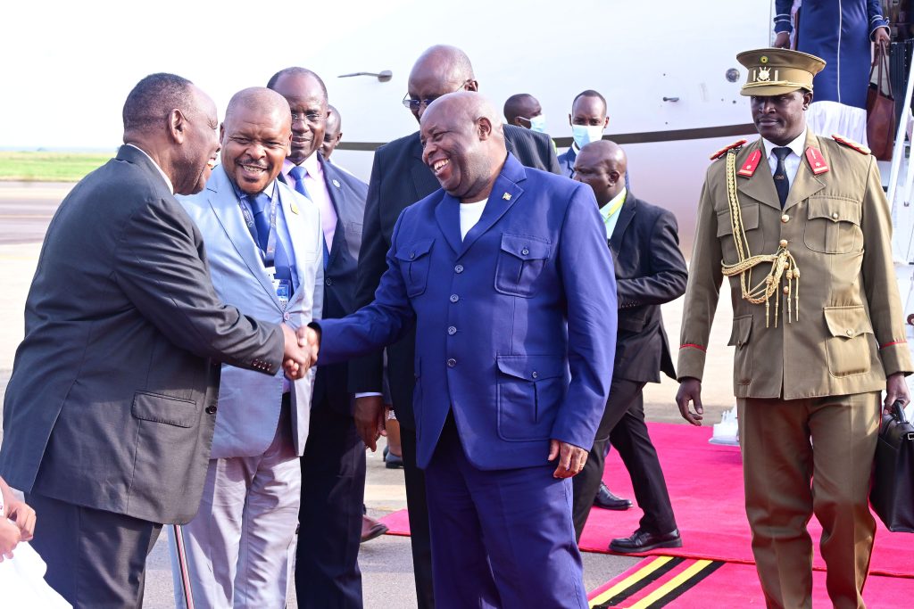 Burundi's President Evariste Ndayishimiye interacts with Uganda's enyoy to Burundi Amb  Kyaligoza (L) as amb Ssemuddu and Hon Rwamirama look on at Entebbe airport on Friday PPU Photo