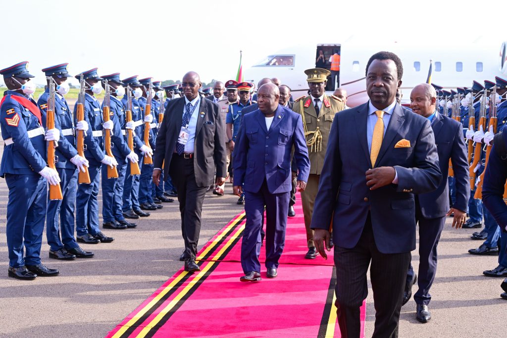 Burundi's President Evariste Ndayishimiye on his arrival at Entebbe airport on Friday. With him is Hon Bright Rwamirama looks on. PPU Photo