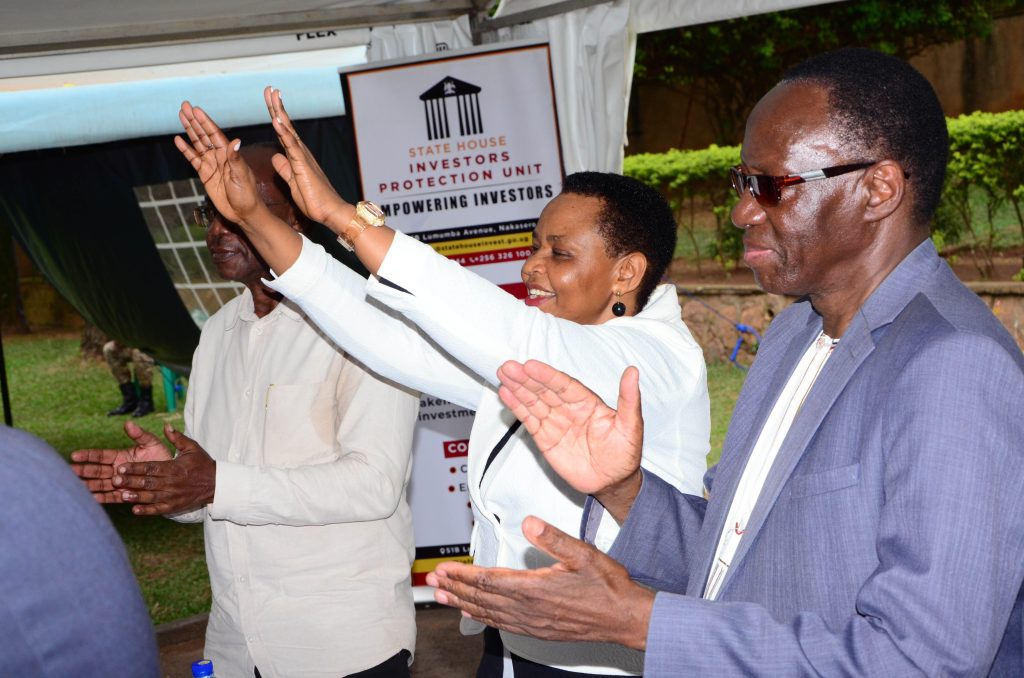 Col. Edith Nakalema, Head of State House Investors Protection Unit and the guests enjoying artist Fred Sebbaale’s performance.