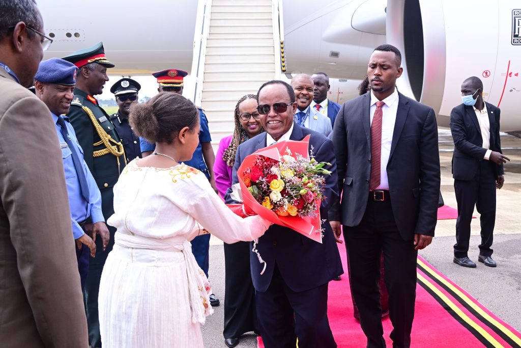 Ethiopia's President Taye Atske Selassie receives a banquet of flowers on his arrival at Entebbe International Airport this morning. He is here to attend the AU Summit in Kampala. PPU Photo