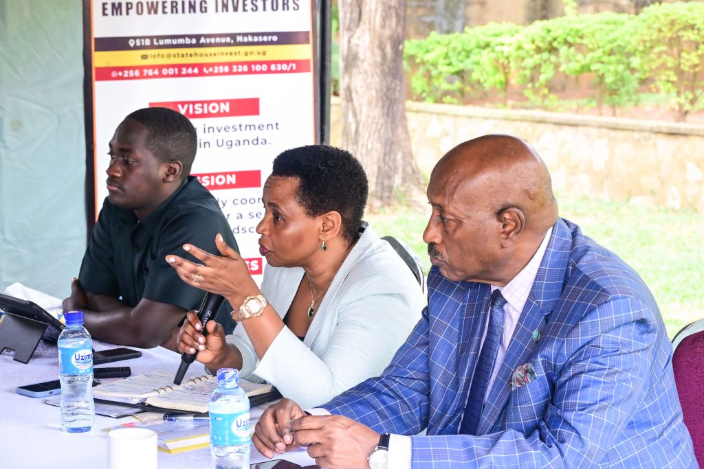 Head of State House Investors Protection Unit Col Edith Nakalema shares a light moment with Makerere University Guild president Vincent Lubega Nsamba at her offices in Nakasero on Friday PPU Photo