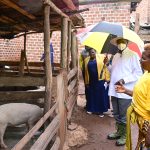 PDM beneficiary Damali Nakayenga L shows President Museveni part of her piggery project at her home in Kikoma Wobulenzi town on Tuesday PPU Photo - 20-May-2025