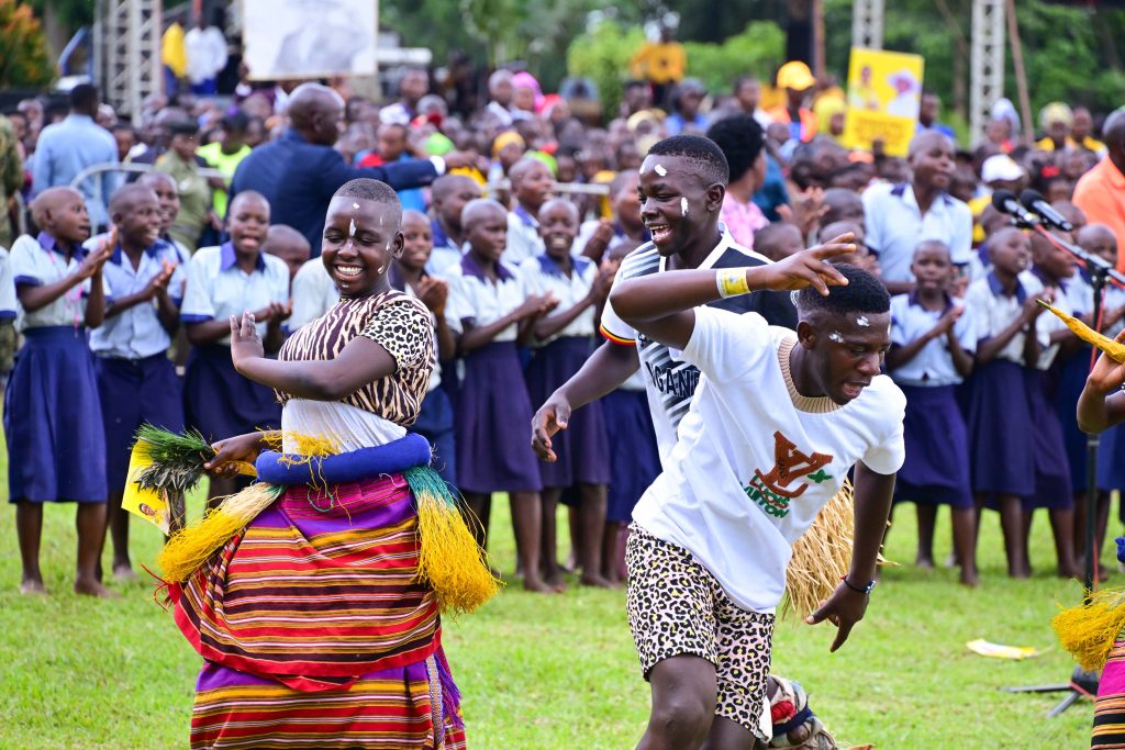 Pupils of St Peters Primary School Kisaru in Kikube district entertaining guests during Hon Grace Mugasas thanksgiving celebrations in Kikube on Friday PPU Photo - State House Uganda President Museveni At A Thanksgiving Ceremony For Hon. Grace Mary Mugasa, The Minister Of State For Public Service, Held At Kisaaru-Kyabayanja Village, Kimbugu Parish In Kabwoya Sub-County, Kikuube District – 24-May-2025
