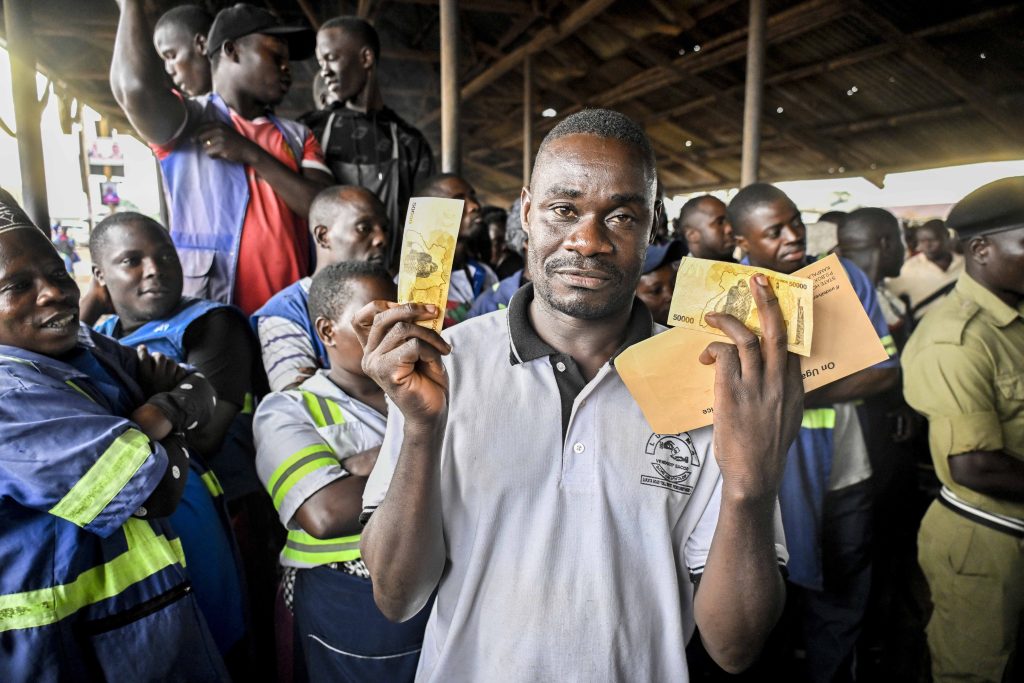 Makanga Ben happily shows off after receiving President Yoweri Kaguta Museveni’s financial support at Lukaya Road Toll market in Lukaya Town in Kulungu district on the 12th August 2025. Photo by PPU/Tony Rujuta