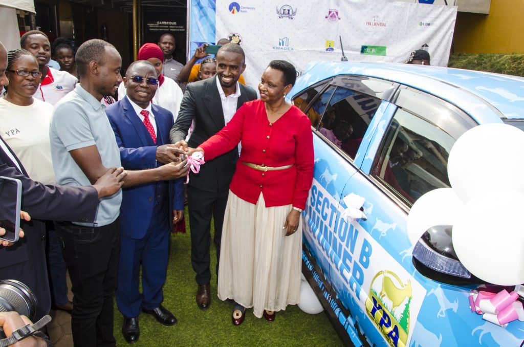 (Front row) Col. Edith Nakalema, Head of State House Investors Protection Unit (Right) accompanied by Archbishop of SDA Church, Pastor Moses Maka Ndimukika (Third right) and Obed Ben Rukuringamamanzi, founder Youth Platform Africa (Second Right) handing over a car key to the Winner of raffle draw Lauben Ndahura (Second Left) This was during the Prize Giving Ceremony held at Youth Platform Africa Offices in Rubaga Kampala on Friday 8 August 2025. PPU PHOTO.