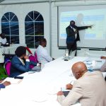 Paul Mwesigwa, Managing Director Uganda Electricity Distribution Company Limited (UEDCL) (standing) gives his presentation during the meeting held at State House Investors Protection Unit Offices on Tuesday 16 September 2025. PPU PHOTO.