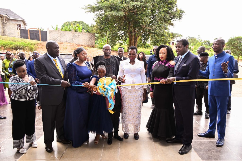Hon Beatrice Akello (C), State Minister for Economic Monitoring cuts the tape as she commissions Life Restoration Ministries Church auditoriam at Bujuko on Sat (1)