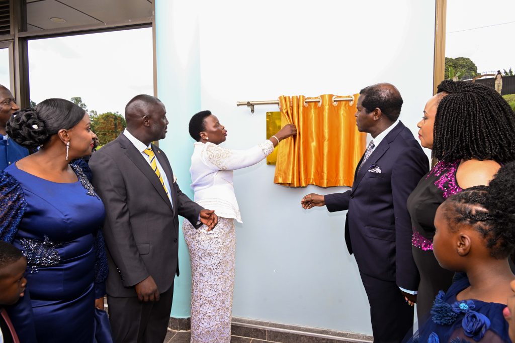 Hon Beatrice Akello (C), State Minister for Economic Monitoring cuts the tape as she commissions Life Restoration Ministries Church auditoriam at Bujuko on Saturda