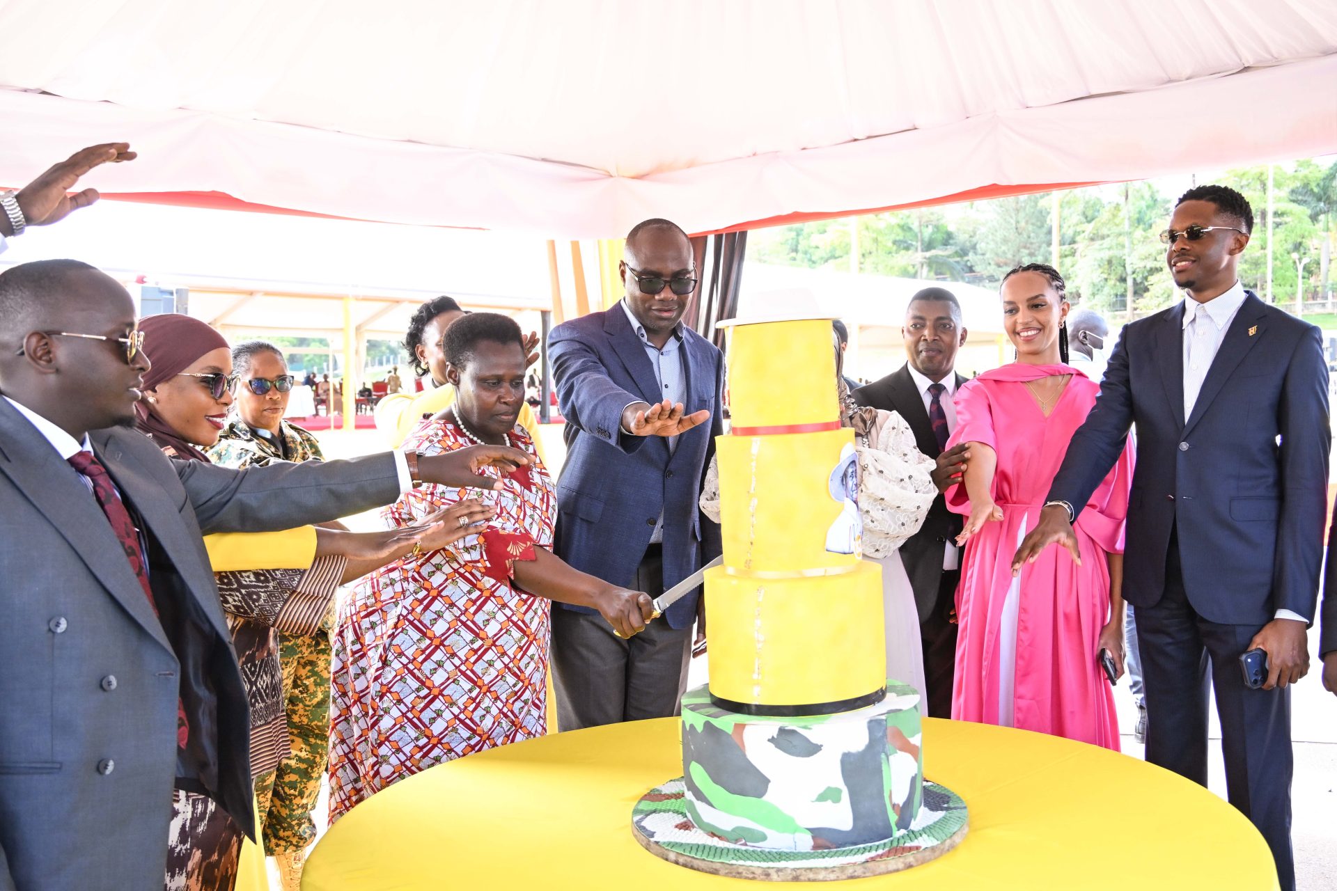 Vice President Jesca Alupo accompanied by Finance Minister Henry Musasizi and Trade minister Amina Mukalazi cut the cake to celebrate President Museveni's 82nd birthday