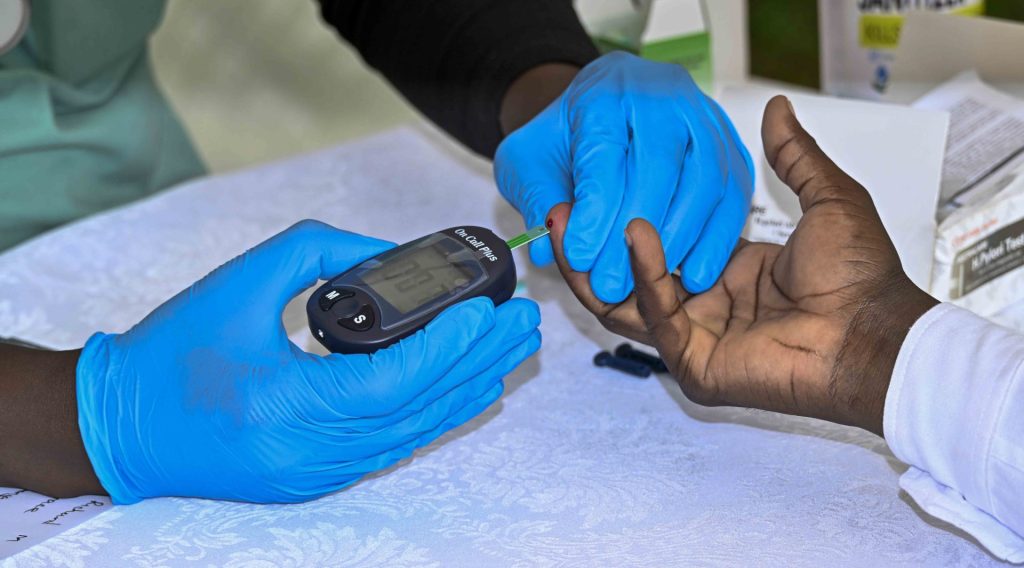 A medical officer checking the blood sugar on a staff during the State House medical camp at the Okello House in Nakasero on the 16th October 2026. Photo by PPU/Tony Rujuta.